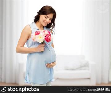 pregnancy, motherhood, holidays, people and expectation concept - happy pregnant woman with flowers touching her big belly over home room background