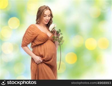 pregnancy, motherhood, holidays, people and expectation concept - happy pregnant woman with rose flower over summer green lights background. happy pregnant woman with white rose flower