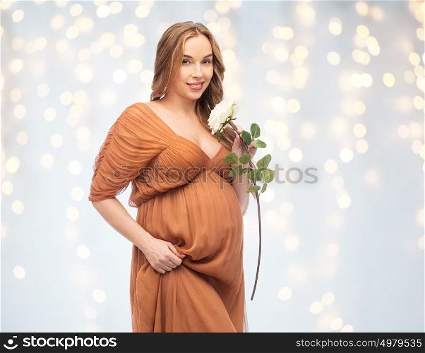 pregnancy, motherhood, holidays, people and expectation concept - happy pregnant woman with rose flower over lights background. happy pregnant woman with white rose flower