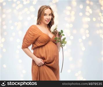 pregnancy, motherhood, holidays, people and expectation concept - happy pregnant woman with rose flower over lights background. happy pregnant woman with white rose flower