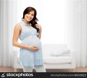 pregnancy, motherhood, people and expectation concept - happy pregnant woman touching her big belly over home living room background