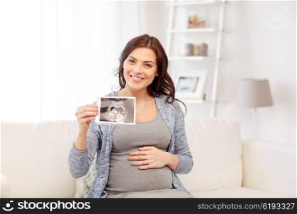 pregnancy, motherhood, people and medicine concept - happy pregnant woman holding at ultrasound image at home