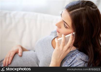 pregnancy, motherhood, technology, people and expectation concept - sad pregnant woman calling on smartphone at home