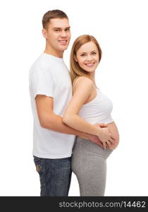 pregnancy, parenthood and happiness concept - happy young family expecting child