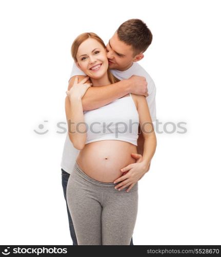 pregnancy, parenthood and happiness concept - happy young family expecting child