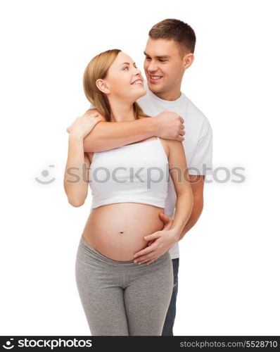 pregnancy, parenthood and happiness concept - happy young family expecting child