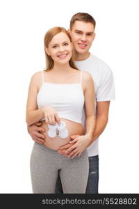 pregnancy, parenthood and happiness concept - happy young family expecting child