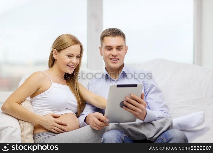 pregnancy, parenthood, internet and technology concept - expecting family with tablet pc computer