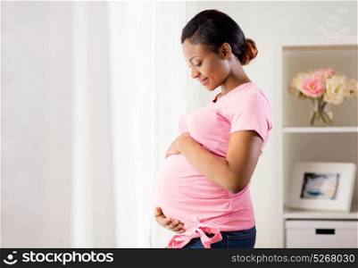 pregnancy, people and expectation concept - happy pregnant african american woman with big belly at home. happy pregnant woman with big belly at home
