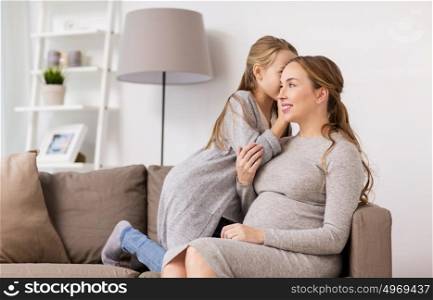 pregnancy, people and family concept - happy girl talking to pregnant woman and whispering secret to her ear at home. happy pregnant woman and girl gossiping at home