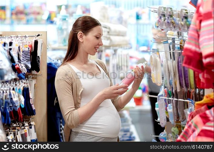 pregnancy, people, sale and expectation concept - happy pregnant woman shopping at children clothing store