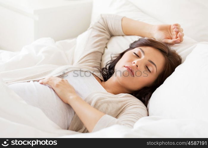 pregnancy, rest, people and expectation concept - happy pregnant woman sleeping in bed at home