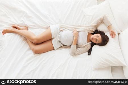 pregnancy, rest, people and expectation concept - happy pregnant woman sleeping in bed at home