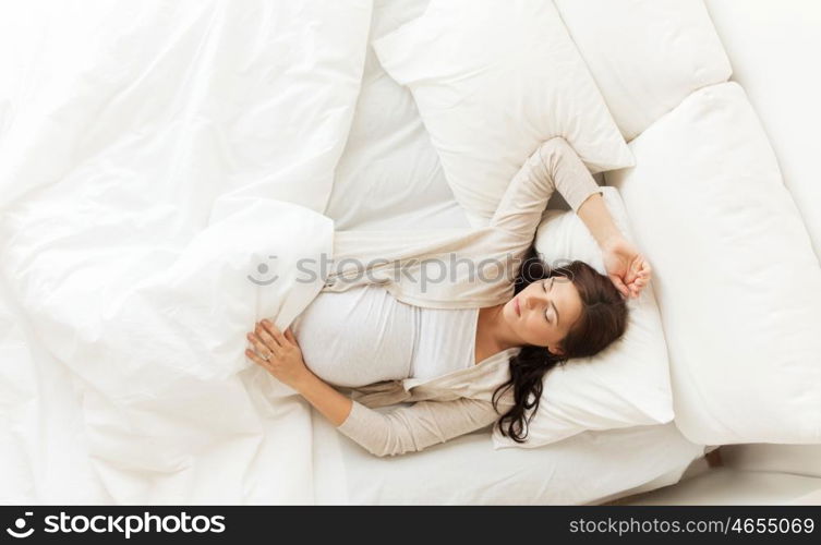 pregnancy, rest, people and expectation concept - happy pregnant woman sleeping in bed at home