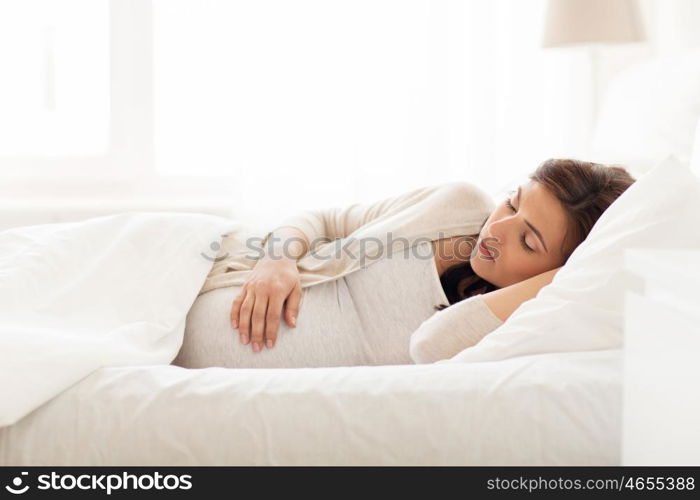 pregnancy, rest, people and expectation concept - happy pregnant woman sleeping in bed at home