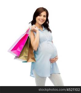 pregnancy, sale, motherhood, people and expectation concept - happy pregnant woman with shopping bags touching her big belly over white background