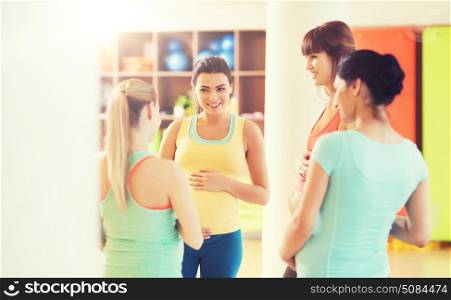 pregnancy, sport, fitness, people and healthy lifestyle concept - group of happy pregnant women talking in gym. group of happy pregnant women talking in gym. group of happy pregnant women talking in gym