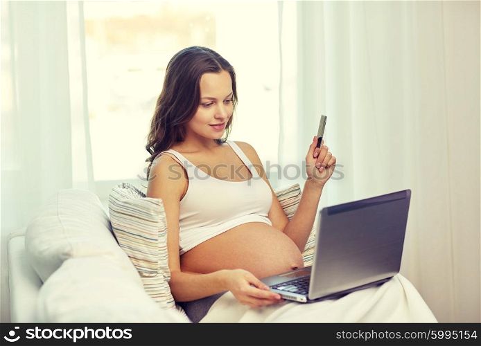 pregnancy, technology, people and expectation concept - happy pregnant woman with laptop and ultrasound image at home