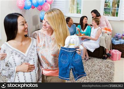 Pregnant Asian Woman with friend at a Baby Shower