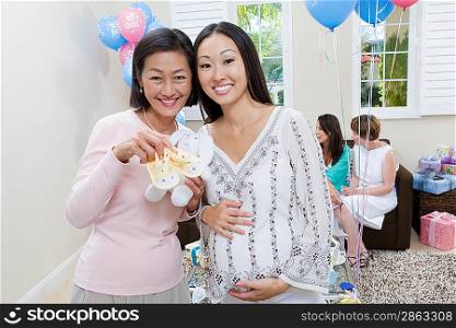 Pregnant Asian Woman with Mother at a Baby Shower