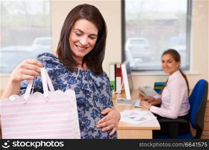 Pregnant Businesswoman Going On Maternity Leave From Office