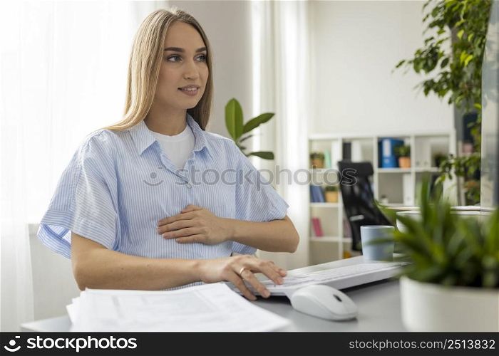 pregnant businesswoman working office