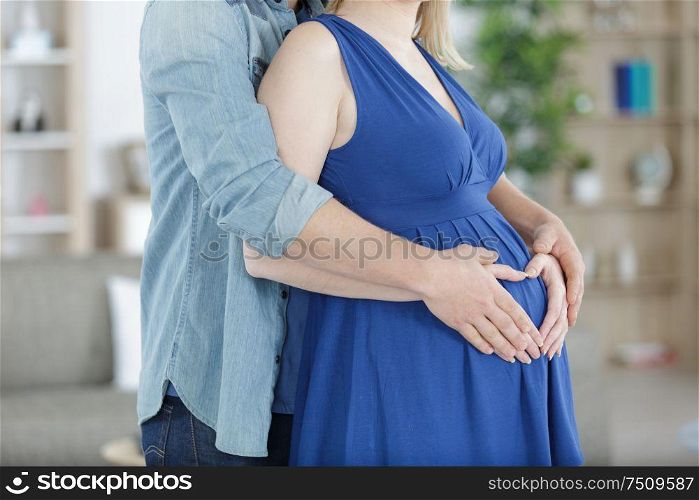 pregnant couple hug pregnant belly