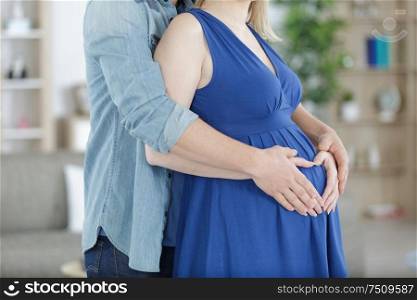 pregnant couple hug pregnant belly