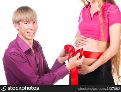 pregnant couple with red silk bow on female stomach