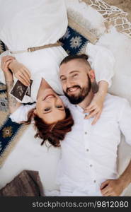 pregnant girl and boyfriend on a picnic by the sea in white clothes