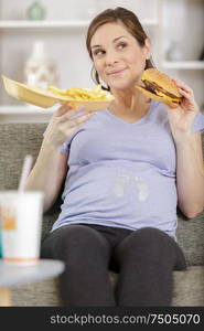 pregnant girl eating a hamburger