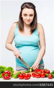 pregnant girl preparing from fresh healthy vegetable salad