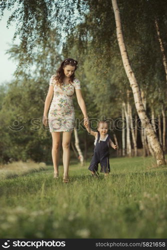 Pregnant mom walking with little child