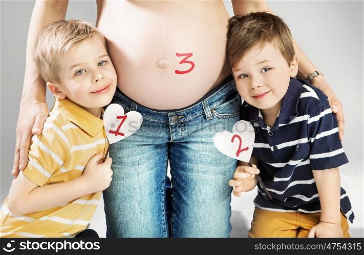 Pregnant mother posing with her happy children