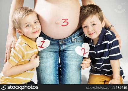 Pregnant mother posing with her happy children