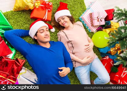 Pregnant wife celevrating christmas with husband. The pregnant wife celevrating christmas with husband