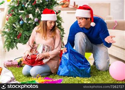Pregnant wife celevrating christmas with husband. The pregnant wife celevrating christmas with husband