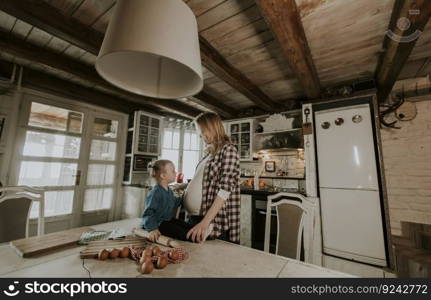 Pregnant woman and little daughter in the rustic kitchen preparing meal