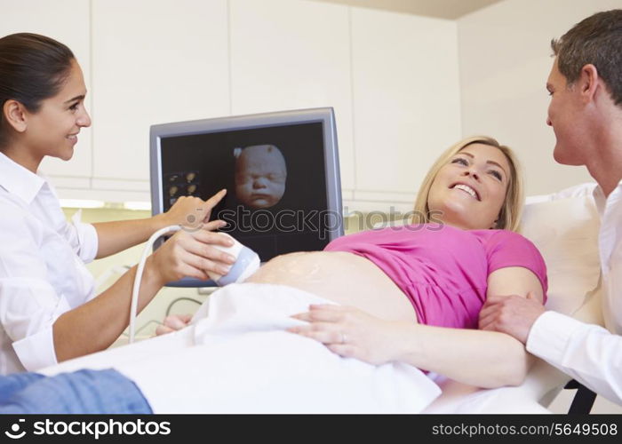 Pregnant Woman And Partner Having 4D Ultrasound Scan