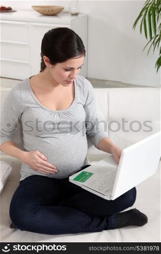 Pregnant woman at a laptop