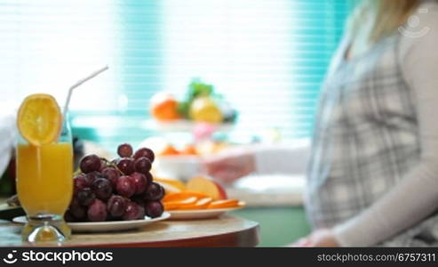 pregnant woman at breakfast in the kitchen