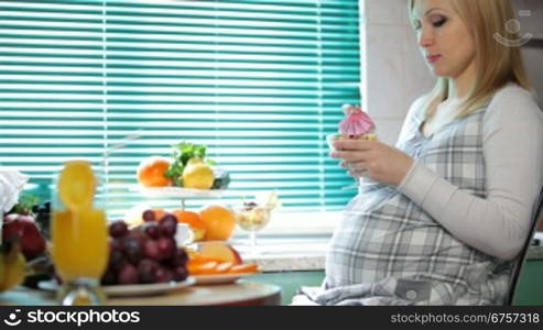 pregnant woman at breakfast in the kitchen