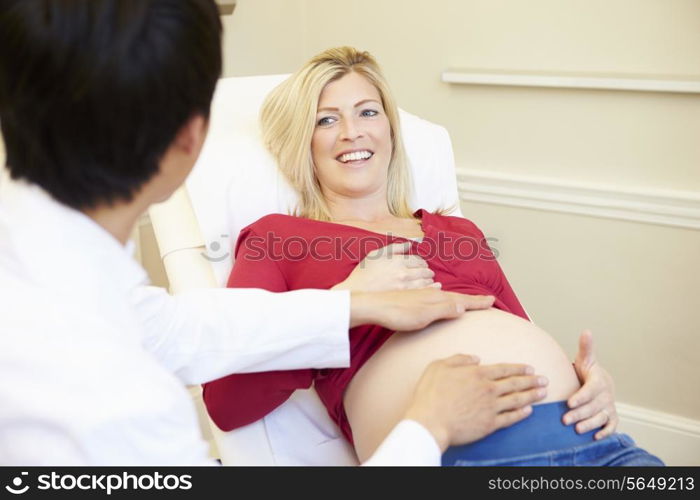 Pregnant Woman Being Given Ante Natal Check By Doctor