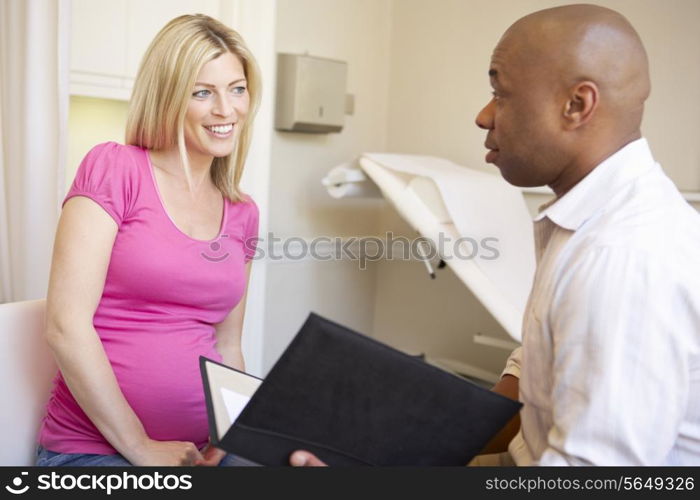 Pregnant Woman Being Given Ante Natal Check By Doctor