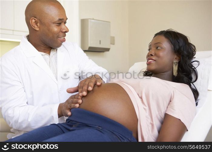 Pregnant Woman Being Given Ante Natal Check By Doctor