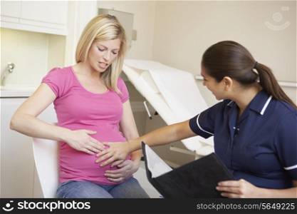 Pregnant Woman Being Given Ante Natal Check By Nurse