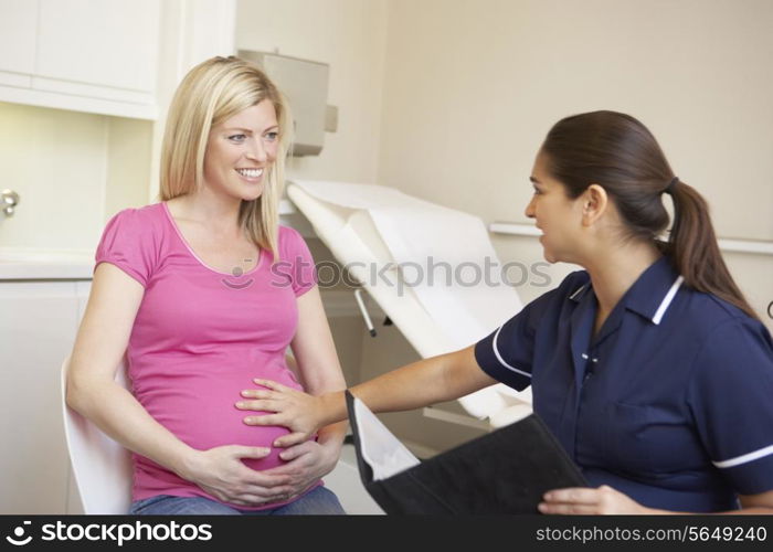 Pregnant Woman Being Given Ante Natal Check By Nurse