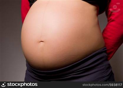 pregnant woman belly in a dark background