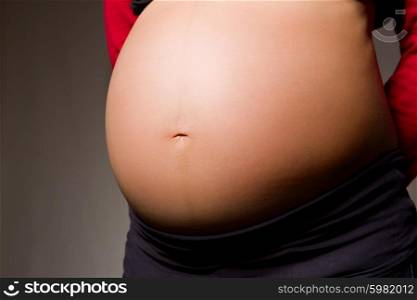 pregnant woman belly in a dark background