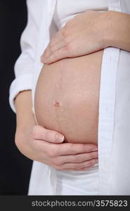 Pregnant woman caressing her belly